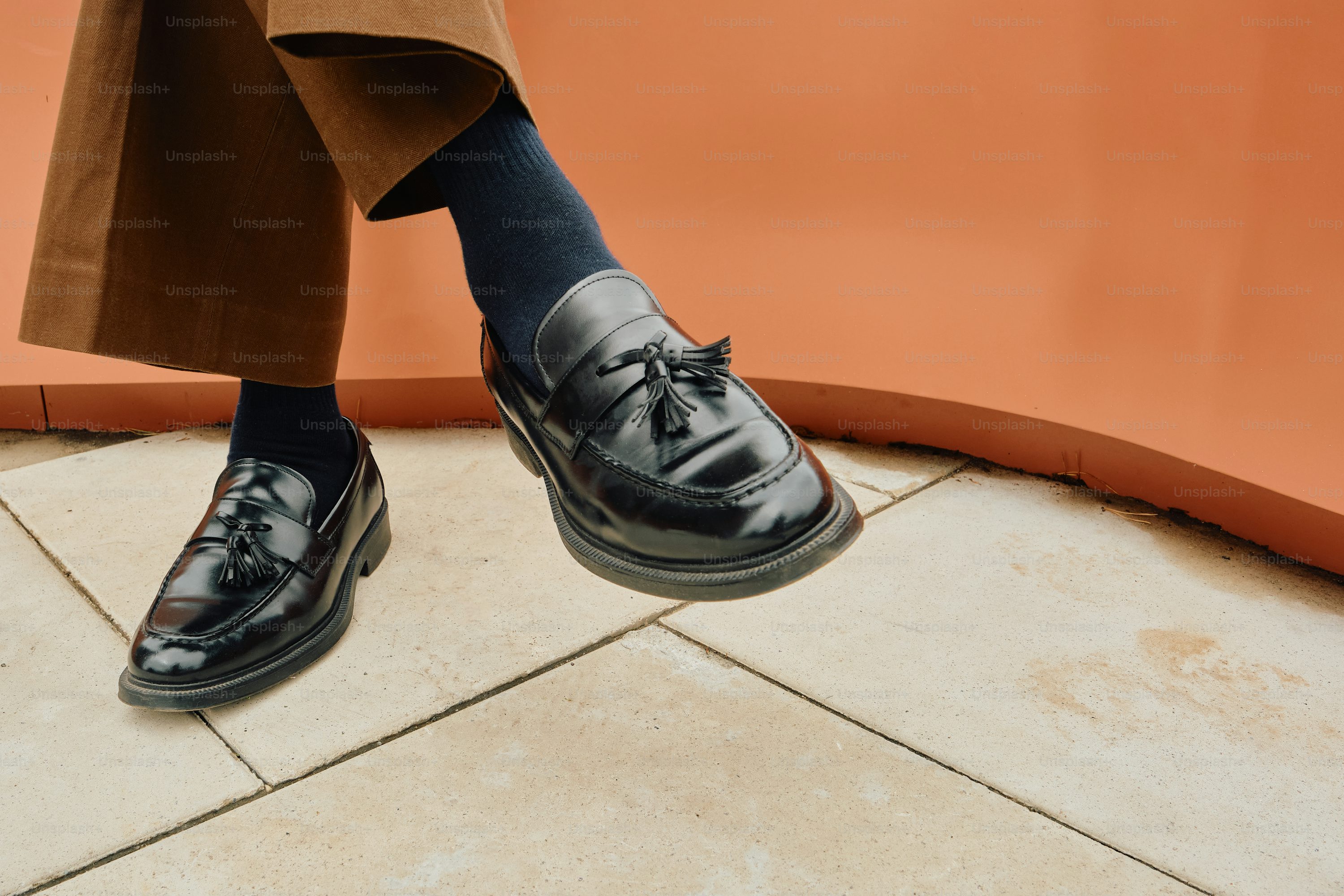 Styled men's loafers with tassels and brown trousers